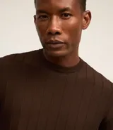 Remera de manga corta color beige, con cuello redondo y tejido texturizado acanalado.