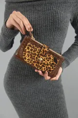 Billetera marrón con textura símil cocodrilo y solapa con estampado animal print.