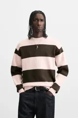 Jersey de punto de tacto suave con diseño de rayas horizontales anchas en color rosa claro y marrón oscuro. Presenta cuello redondo, manga larga y terminaciones en rib.