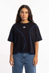 Remera negra de corte boxy fit y mangas cortas, con costuras visibles decorativas en color azul y logo pequeño en el pecho.