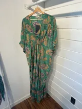 Kaftan largo con estampado floral en tonos turquesa y fucsia, con detalles de guarda pampa en los bordes.