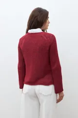 Sweater de punto color verde oliva con escote bote y mangas largas acampanadas.