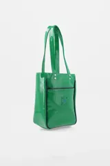 Bolso tipo tote de charol color marrón, con diseño vertical, doble asa de hombro y logo de la marca estampado en la parte inferior. Cuenta con terminaciones en contraste y estructura rígida.