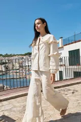 Pantalón palazzo color coral de lino con cintura alta y bolsillos laterales.