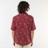 Camisa de manga corta confeccionada en mezcla de lino, color bordó, con cuello cubano y diseño estampado de flores en trazos blancos.