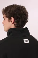 Sudadera negra con cierre de cremallera metálica en el cuello y estampado con texto en el pecho.