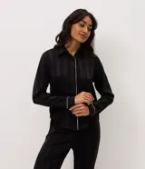 Pijama largo Lov de dos piezas confeccionado en satén negro con rayas sutiles y detalles de vivo en contraste. Consta de una camisa de manga larga con cuello y solapa, abotonado frontal, y un pantalón de calce amplio con cintura elastizada.