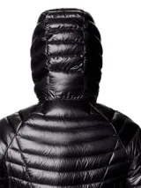 Campera puffer ultraligera de color negro con capucha, marca Mountain Hardwear modelo Ghost Whisperer. Presenta tejido ripstop, aislamiento de plumón, cierre frontal completo y bolsillos laterales con cremallera.