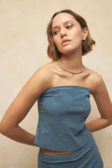 Top strapless negro con diseño tipo corset, de textil engomado y texturizado.