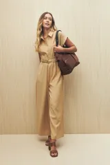 Mono largo color beige, estilo camisero, con botones forrados, cuello clásico, mangas cortas y cinturón a tono.