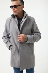 Gabán gris con cuello alto, cierre con botones y pechera desmontable con cierre.