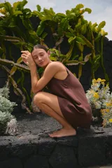 Vestido corto color marrón, de lino y rayón, con cuello redondo y ruedo ancho.