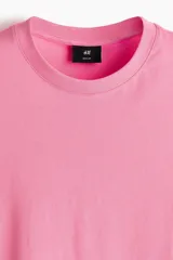 Remera de algodón liviano color rosado, con cuello redondo y diseño clásico de manga corta.