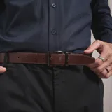 Cinturón reversible de cuero con hebilla metálica rectangular de diseño clásico.