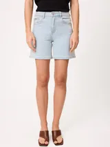 Short de denim elastizado de tiro alto, color beige, con bolsillos delanteros y traseros, y cierre frontal con botón y cremallera.