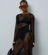 Vestido midi de encaje negro con diseño de transparencia, corte recto, cuello redondo y mangas largas.