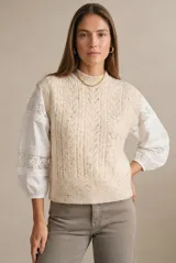 Chaleco de punto con textura trenzada, color beige melange, de cuello redondo y corte al cuerpo.