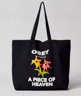Bolso tipo tote bag color crudo, con asas de algodón y estampado con el logo de Obey, flores y la frase "A Piece of Heaven".