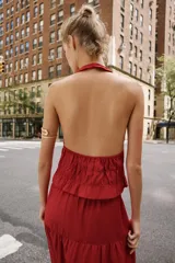 Falda midi color rojo oscuro con diseño de paneles fruncidos, cintura elástica con cordón ajustable y abalorios decorativos.