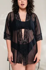 Bata negra de microtul con puntitos y detalles de puntilla elastizada en el borde. Incluye lazo de ajuste en la cintura.