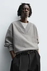 Sudadera de corte relajado confeccionada en algodón con interior de rizo. Presenta cuello en pico y manga larga con acabados en rib.