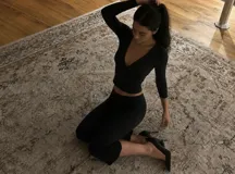 Pantalón capri negro de corte ajustado, con diseño liso y largo por debajo de las rodillas.
