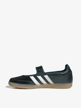 Zapatillas Adidas Samba Jane estilo Mary Jane, de color verde oscuro con las tres tiras blancas y suela de goma translúcida. Cuenta con una tira con velcro en el empeine y detalle de la inscripción 'SAMBA' en el lateral.