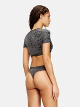 Top cropped gris oscuro de manga corta con estampado laminado integral de efecto desgastado y banda elástica inferior con el logotipo de la marca.