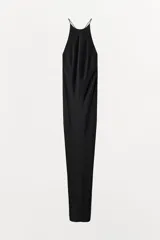 Vestido largo de estilo lencero confeccionado en viscosa, con cuello redondo, tirantes finos cruzados y detalle de nudo con abertura en la espalda.