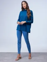 Polera negra de tejido soft con cuello alto y mangas largas con aplique de botones.