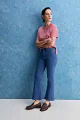 Jean azul de tiro alto con fit bootcut, ajustado en caderas y muslos, con apertura sutil desde la rodilla.