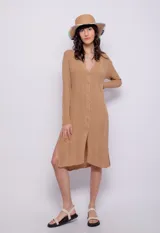 Cárdigan largo color beige de tejido de punto acanalado, con siete botones y aberturas laterales.