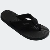 Ojotas Havaianas Surfer Coast de color negro, con tiras de tela texturizada y suela con diseño ondulado.