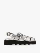 Sandalias plateadas con tiras entretejidas, hebilla lateral y suela track negra.