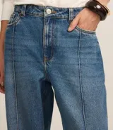 Pantalón wide leg de jeans azul con cintura alta, trabillas en la cintura y friso delantero.