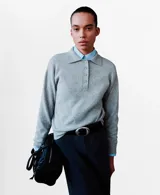 Jersey de punto gris con cuello polo y cierre frontal de botones, de manga larga y calce relajado.