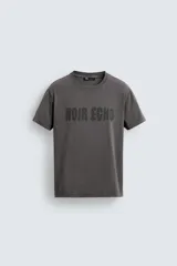 Camiseta de cuello redondo y manga corta con efecto lavado. Presenta una estampa frontal con el texto 'NOIR ECHO' en un tono más oscuro que la prenda.