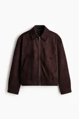 Campera marrón de tejido suave con acabado cepillado, cuello camisero, cierre frontal y bolsillos laterales.