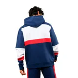 Canguro deportivo Umbro del Club Nacional de Football, con capucha y cordones ajustables. Presenta un diseño tricolor en azul, blanco y rojo, con el logo de la marca y el escudo del club bordados en el pecho. Incluye bolsillo frontal tipo canguro y puños elásticos.