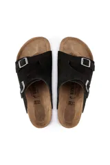 Sandalias Birkenstock Zürich con dos correas de ante negro y hebillas ajustables. La plantilla es de corcho y látex con forro de ante. La suela es de goma EVA.