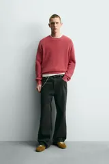Sweater relaxed fit de canalé, color negro con efecto lavado, cuello redondo y manga larga con acabados en rib.