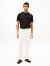 Remera de manga corta Tommy Hilfiger confeccionada en tejido de piqué de algodón. Presenta un diseño de corte regular con cuello redondo acentuado por ribetes tricolores y un bolsillo de parche en el pecho.