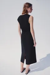 Vestido midi negro de cuello redondo y manga sisa, con detalle de drapeado en la cintura y cierre lateral con cremallera oculta.