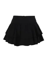 Pollera corta negra de estilo gótico con volados, detalles de cordones laterales y aplique central de encaje con dije de cruz metálica.