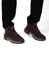 Bota de trekking Caterpillar modelo Surge Hiker, de color marrón con suela y entresuela en tonos beige y marrón claro. Confeccionada en nubuck encerado y malla de nailon, cuenta con cordones bicolores y detalles del logo de la marca en el lateral y la lengüeta.
