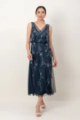 Vestido midi azul marino de tul, sin mangas, con escote en V y delicado bordado de flores con canutillos y lentejuelas en tonos celestes.