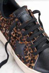 Zapatillas bajas con capellada de cuero con estampado animal print y puntera de cuero negro.
