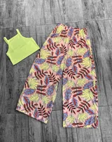 Pantalón tipo palazzo de corte amplio y tiro alto con cintura elástica. Presenta un estampado colorido de hojas sobre fondo rosado.