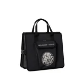 Bolso negro tipo tote con doble asa corta, bolsillo frontal con cierre de velcro y logo Rip Curl estampado.