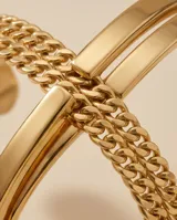 Pulsera esclava de acero con baño de oro, diseño de cadena de eslabones entrelazados con acabado brillante.